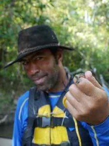 Hercilio holds a small snake that likes to live in the trees.